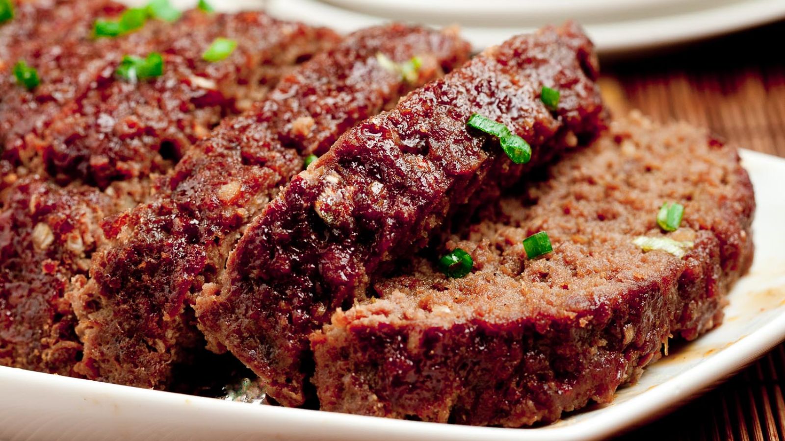 Sliced teriyaki meatloaf on a plate.
