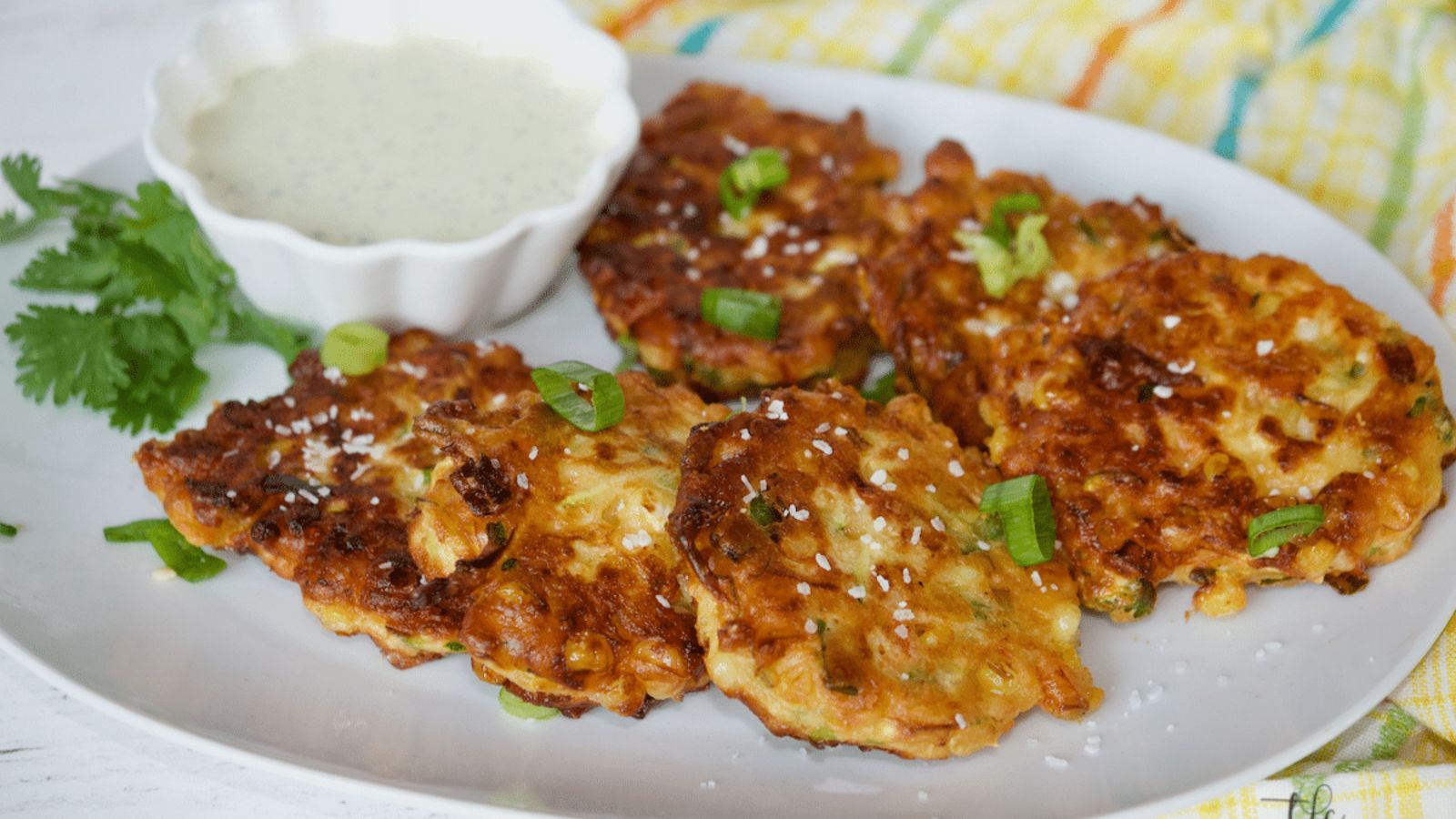 Zucchini corn fritters with dip on the side.