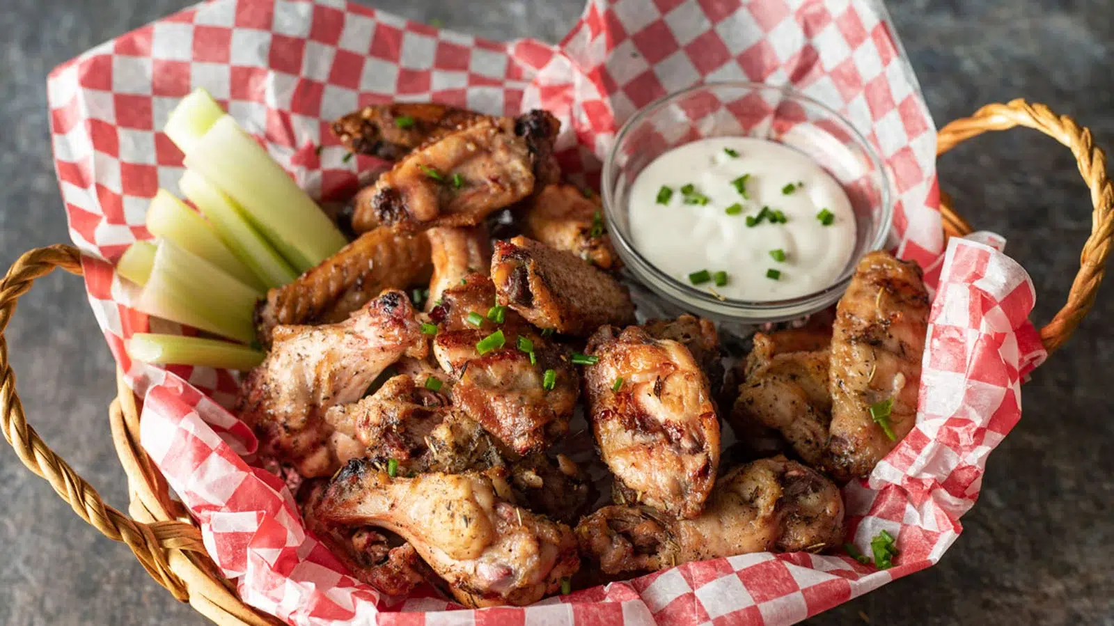 Smoked chicken wings in a basket.