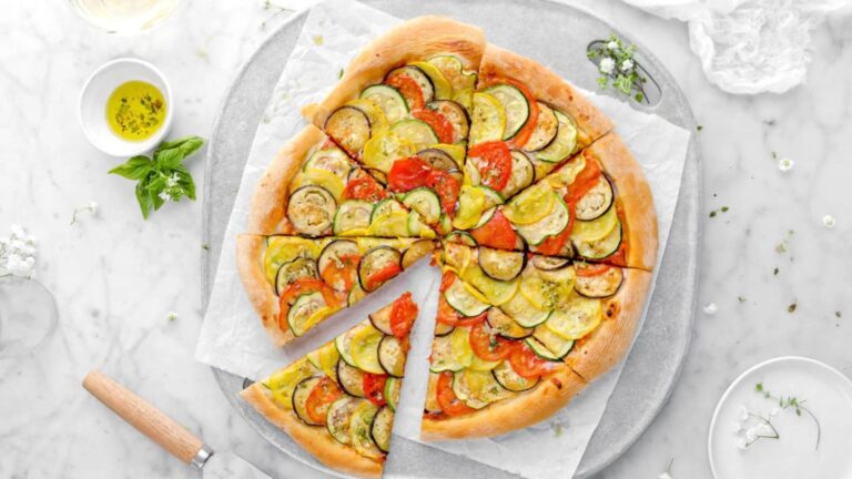 Pizza on a sheet of parchment paper.