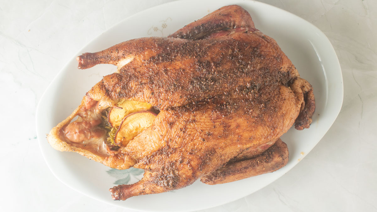 Smoked duck on a white platter.