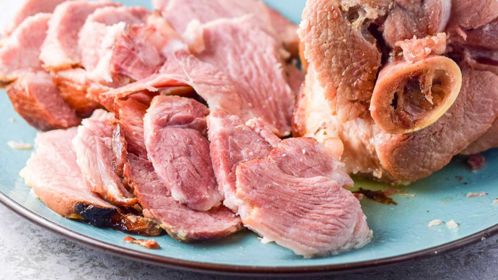 Sliced pork shoulder on a plate.
