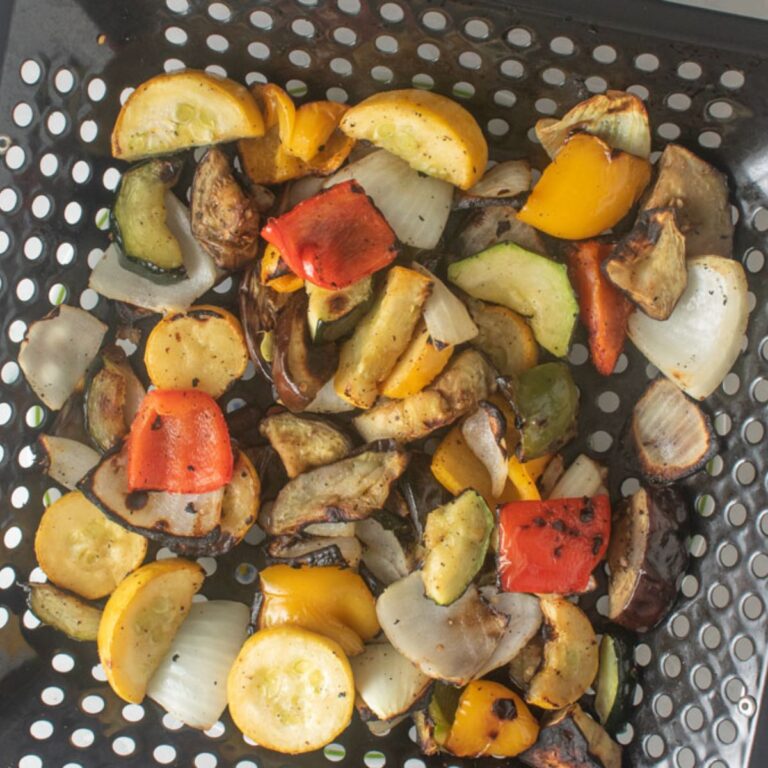 Smoked vegetables in a grill basket.