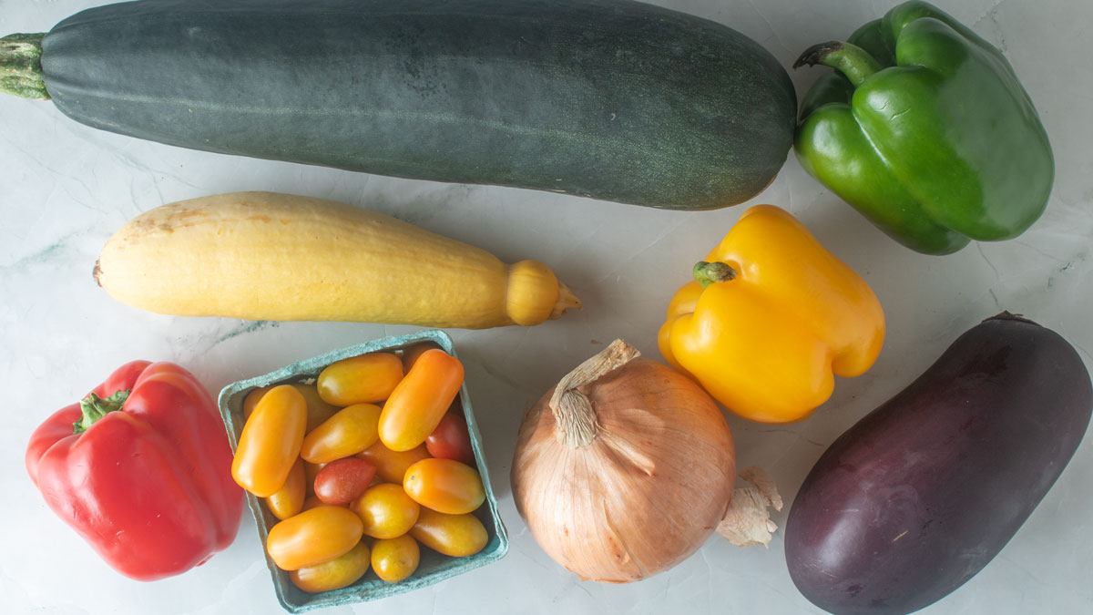Vegetables on a greenish board.