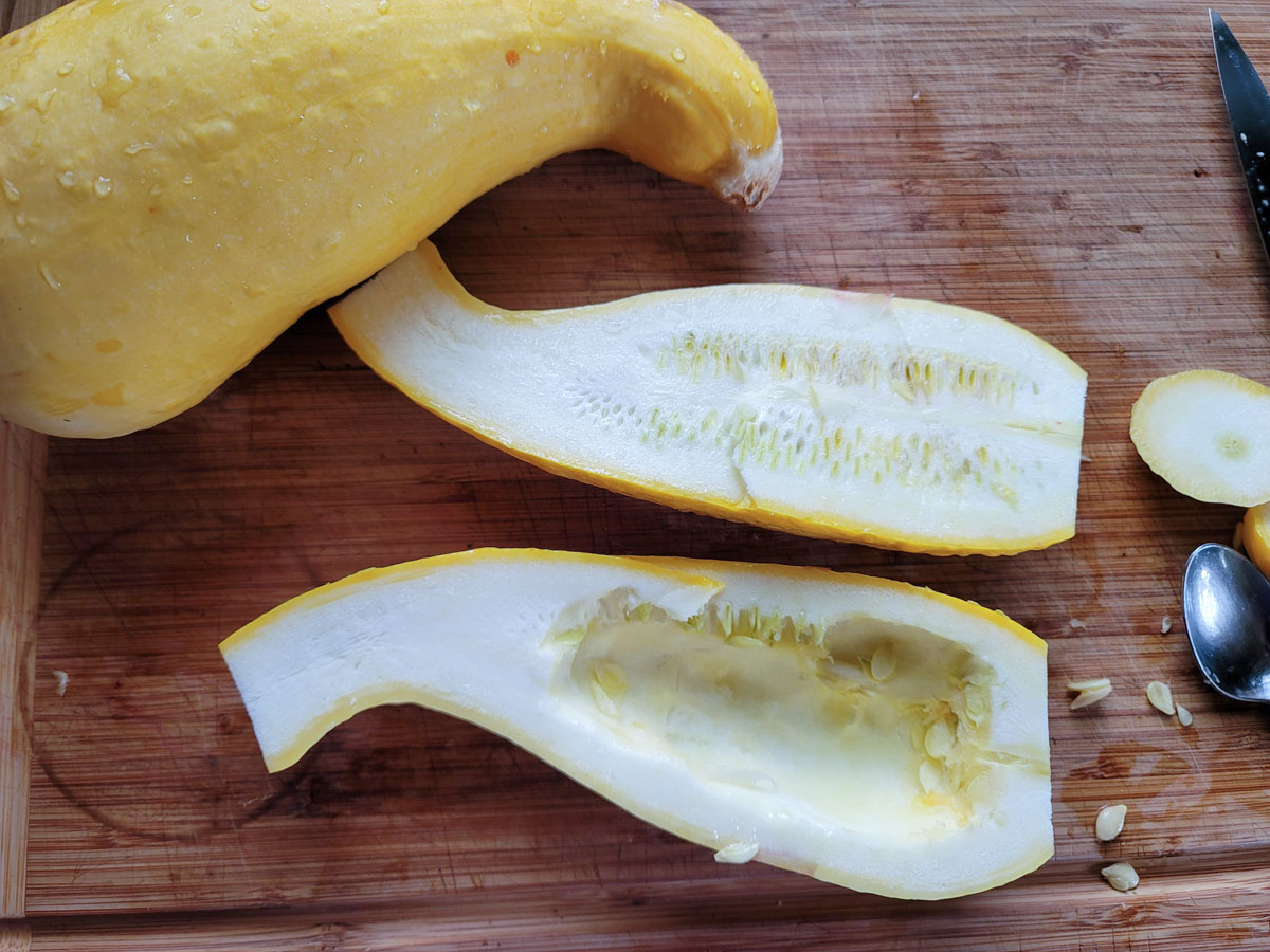Squash cut in half with the seeds scooped out of half.