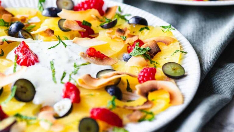 Pineapple carpaccio dessert with berries.