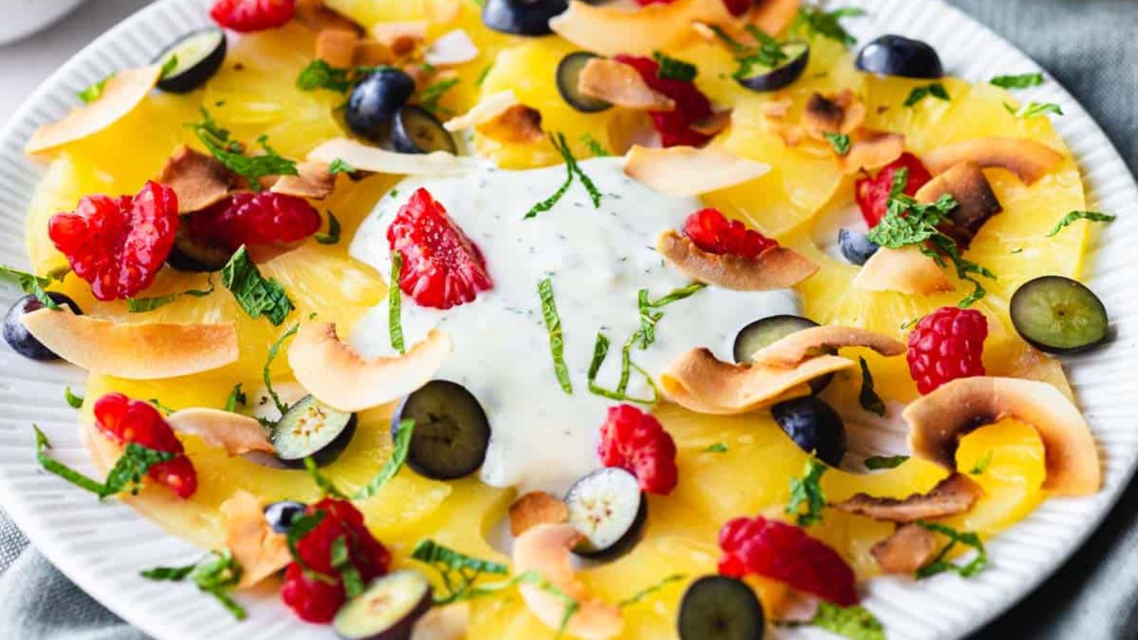 Pineapple carpaccio dessert with berries.