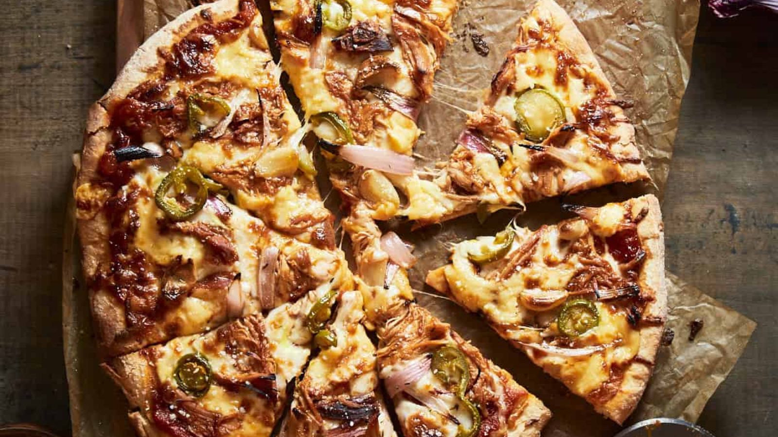 BBQ chicken pizza with slices.