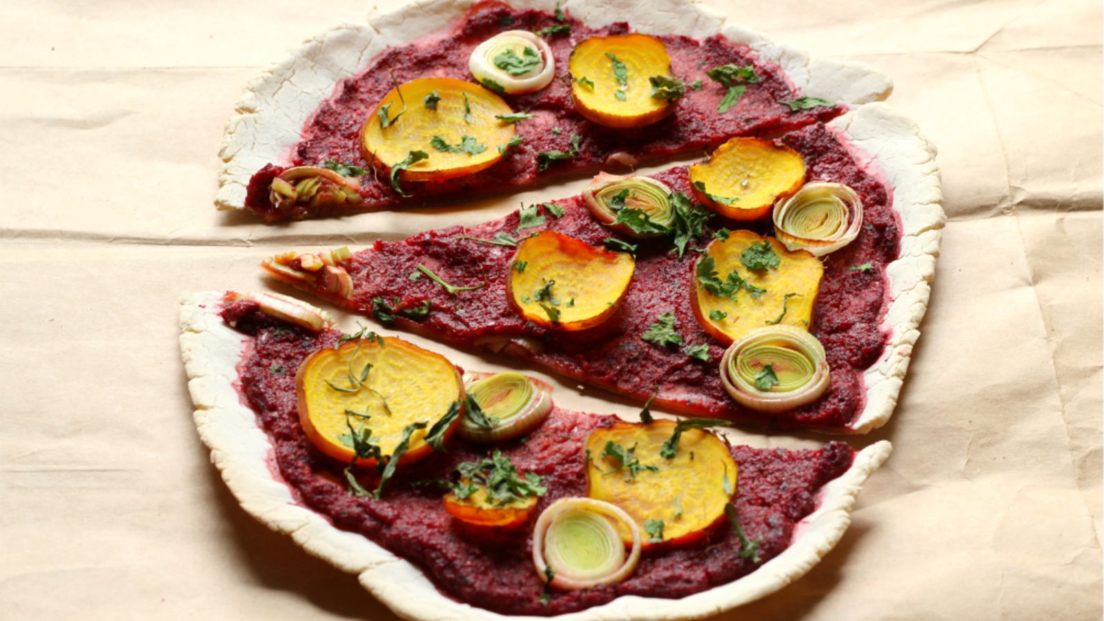 Slices of beet leek cassava pizza.