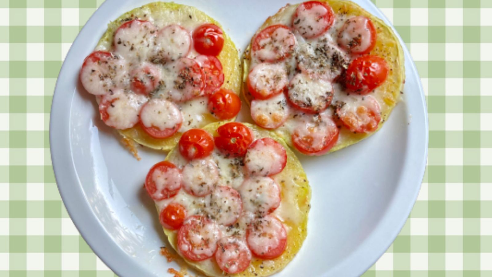 Three mini pizzas on a plate.