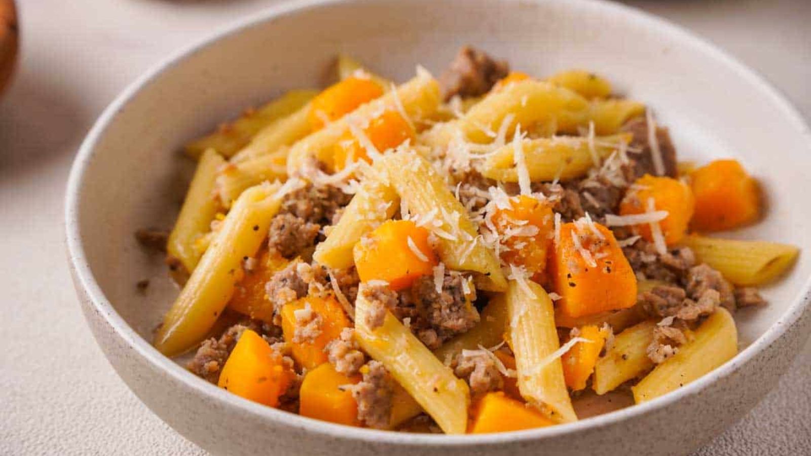 Butternut squash sausage pasta in a bowl.