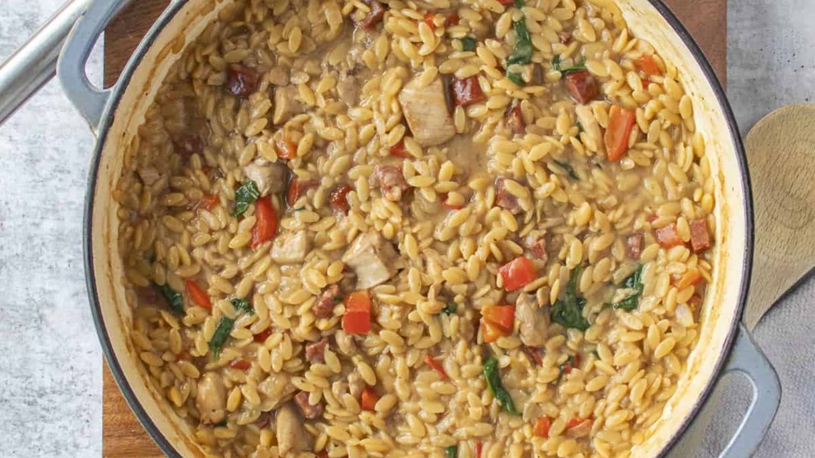 Chicken and chorizo orzo in a pot.