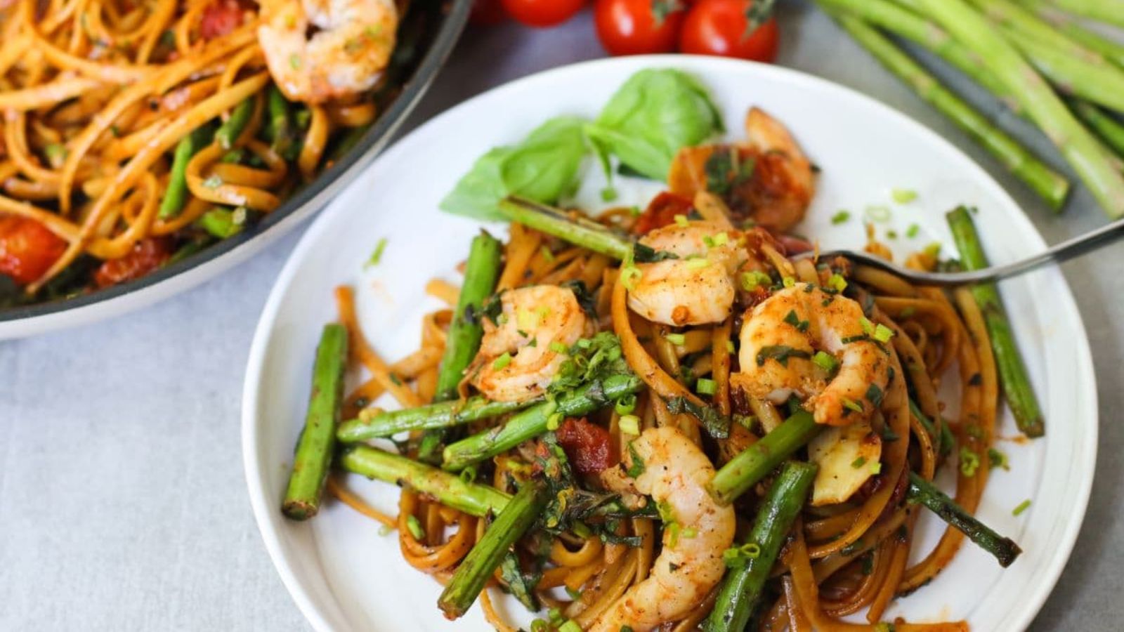 Tomato basil pasta with shrimp on top.