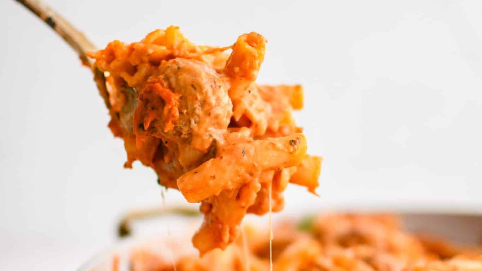 A spoon of meatball casserole.