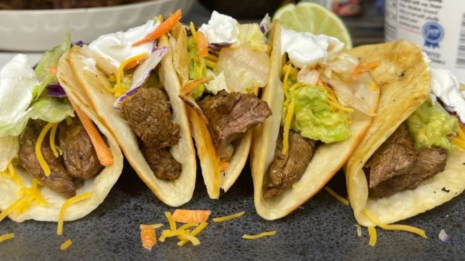 Five steak tacos close up shot.