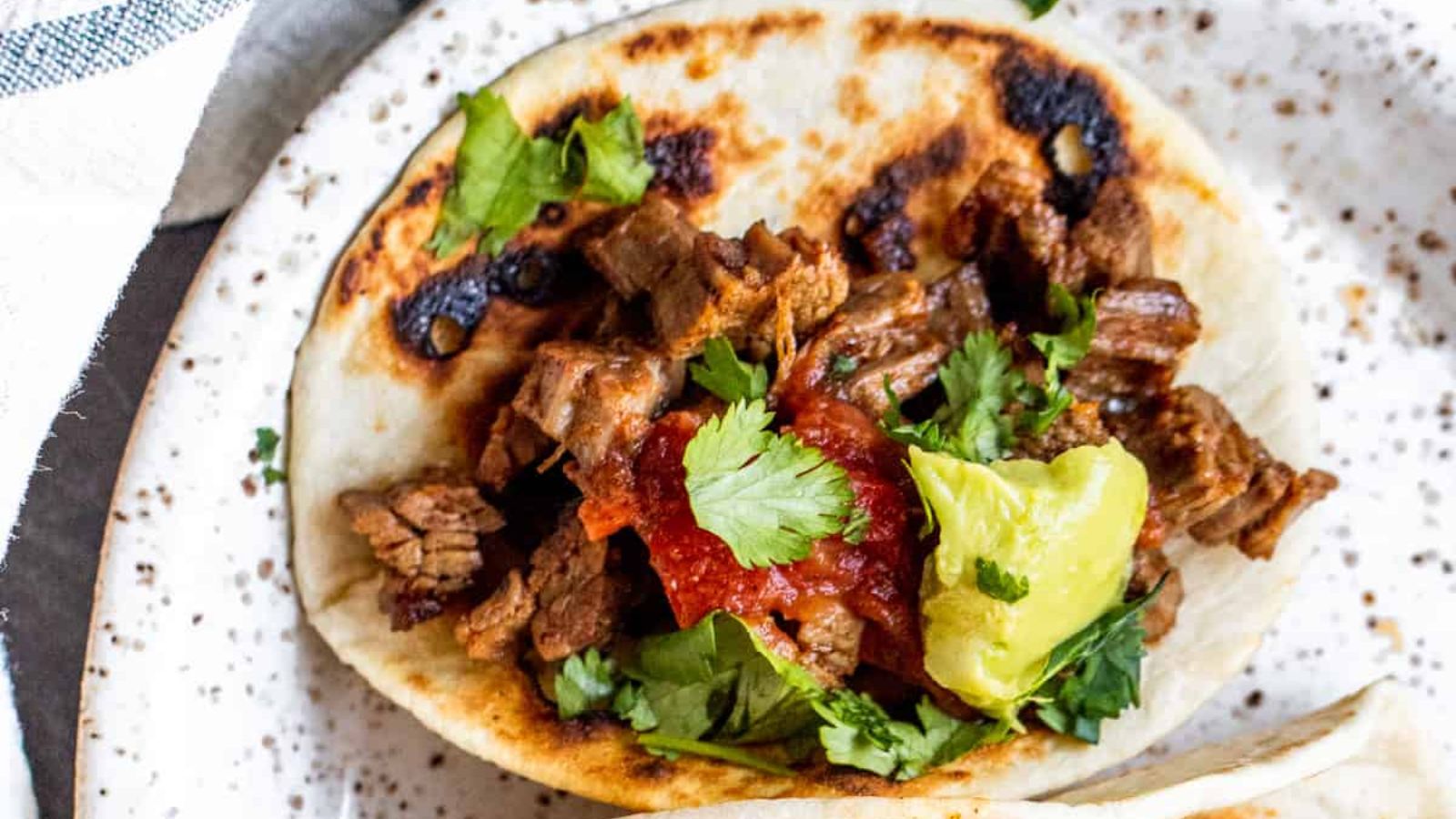 Carne asada tacos on a plate.