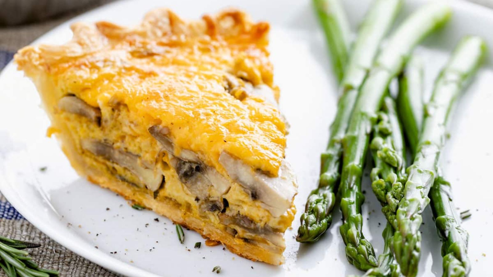 A slice of mushroom quiche with asparagus.
