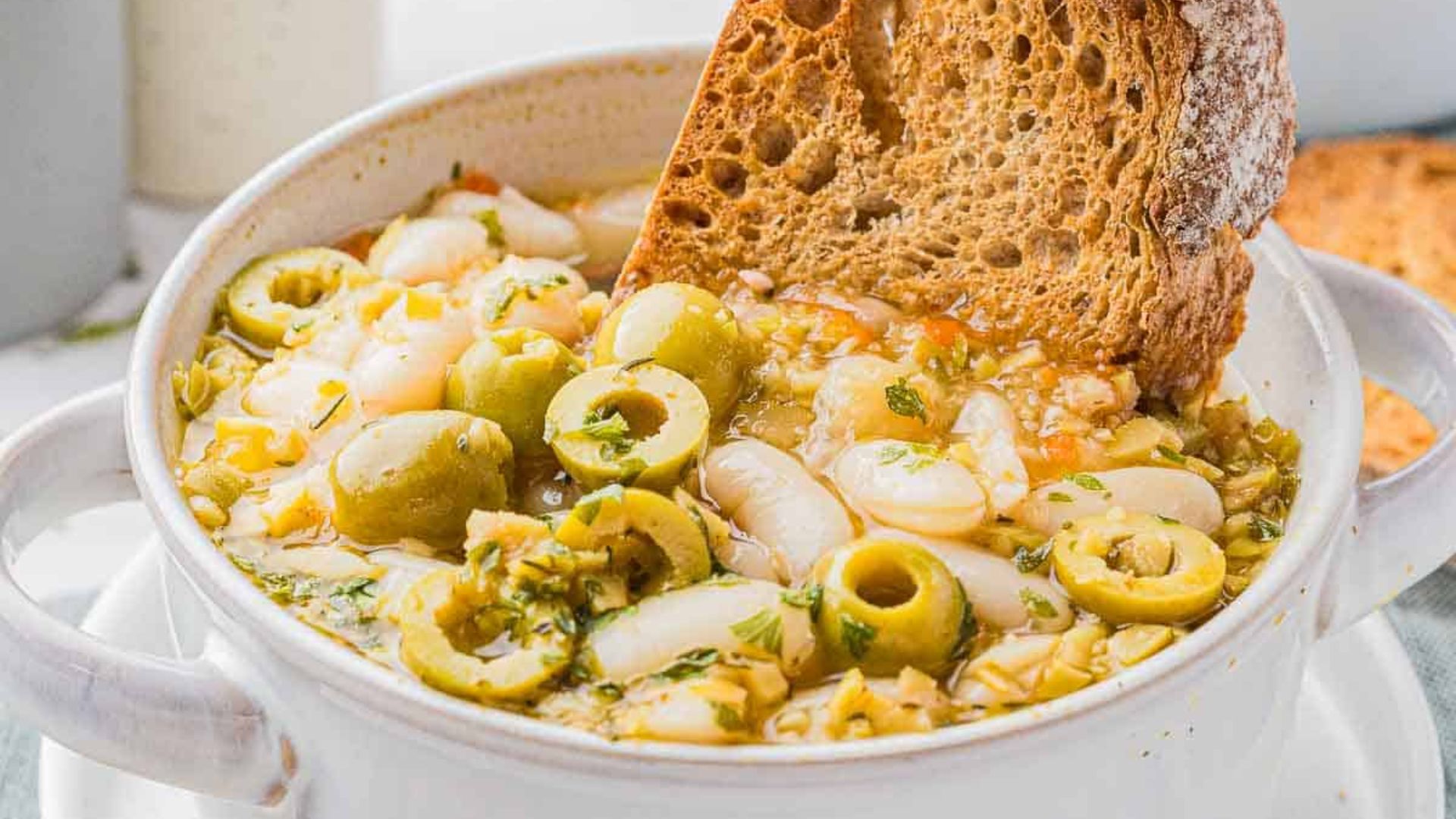 Green olive soup with bread.