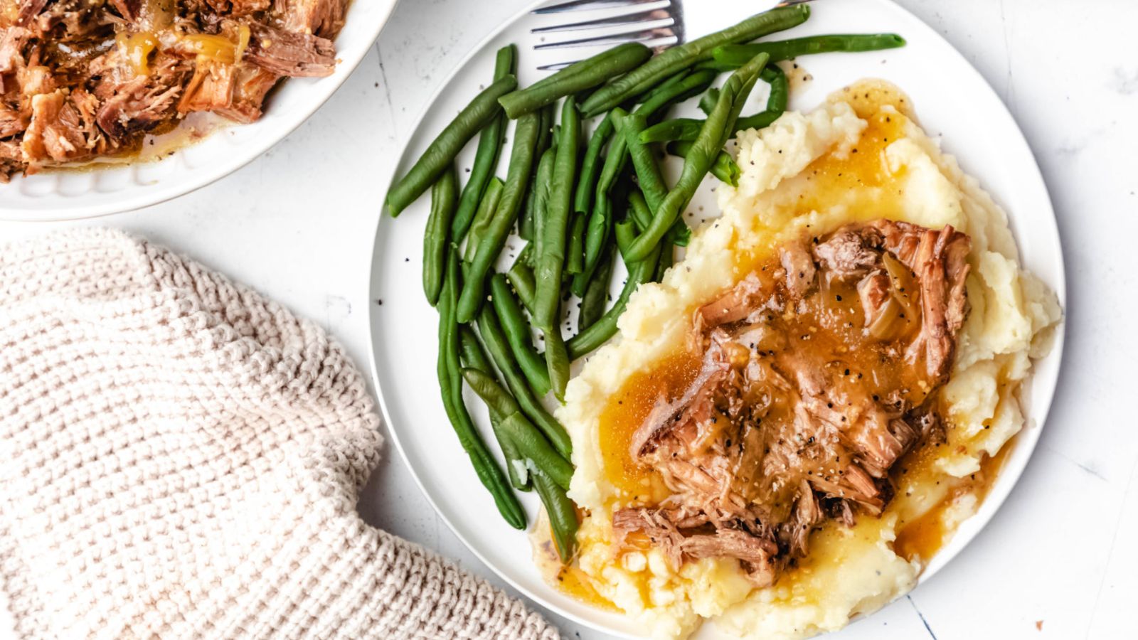 Onion pot roast with mashed potatoes and green beans.