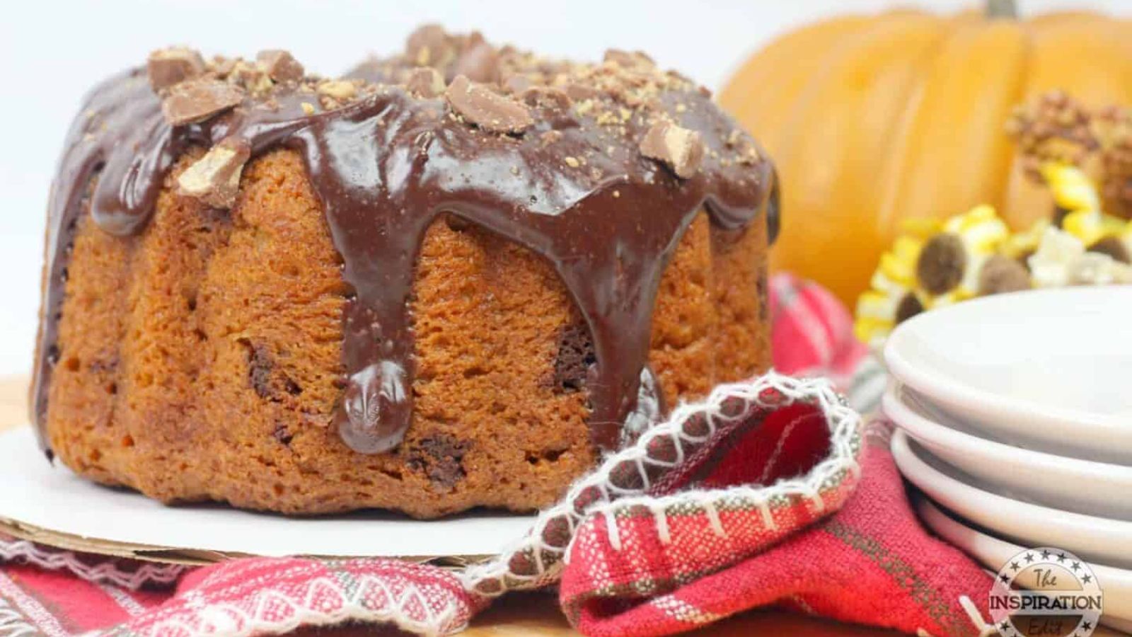 Pumpkin bundt cake with chocolate sauce on top.