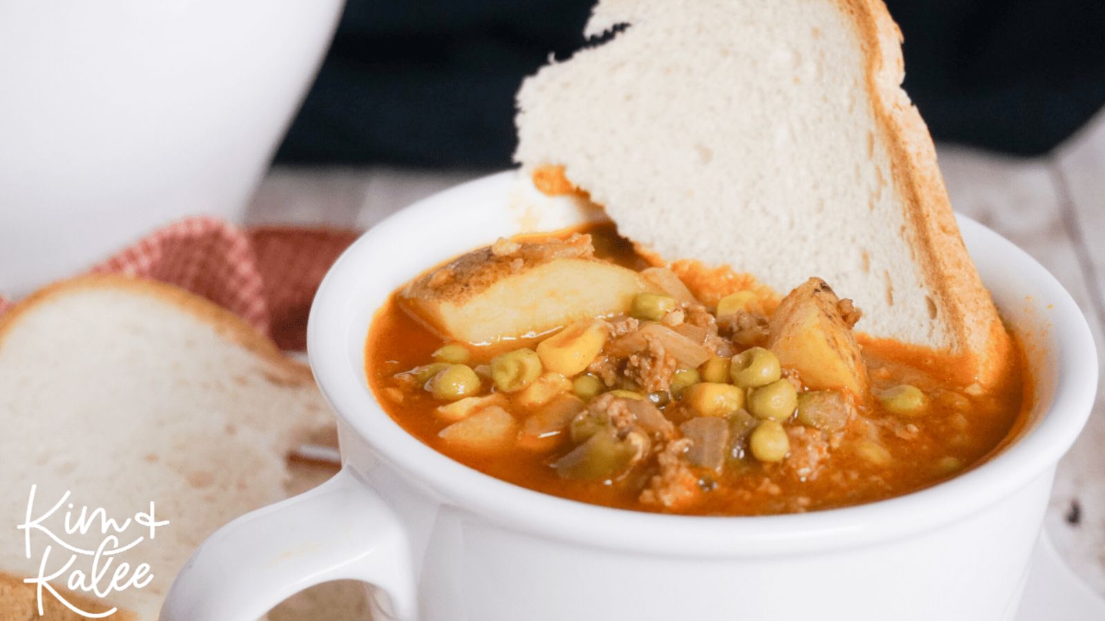 Vegetable and hamburger soup with bread.