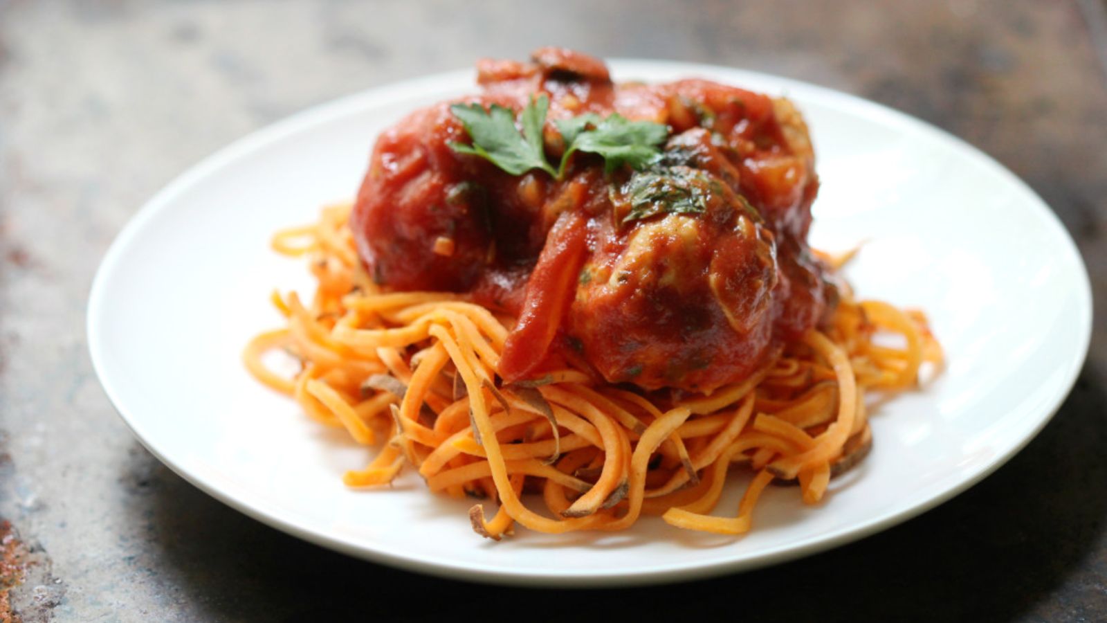 Spaghetti with meatballs on top.