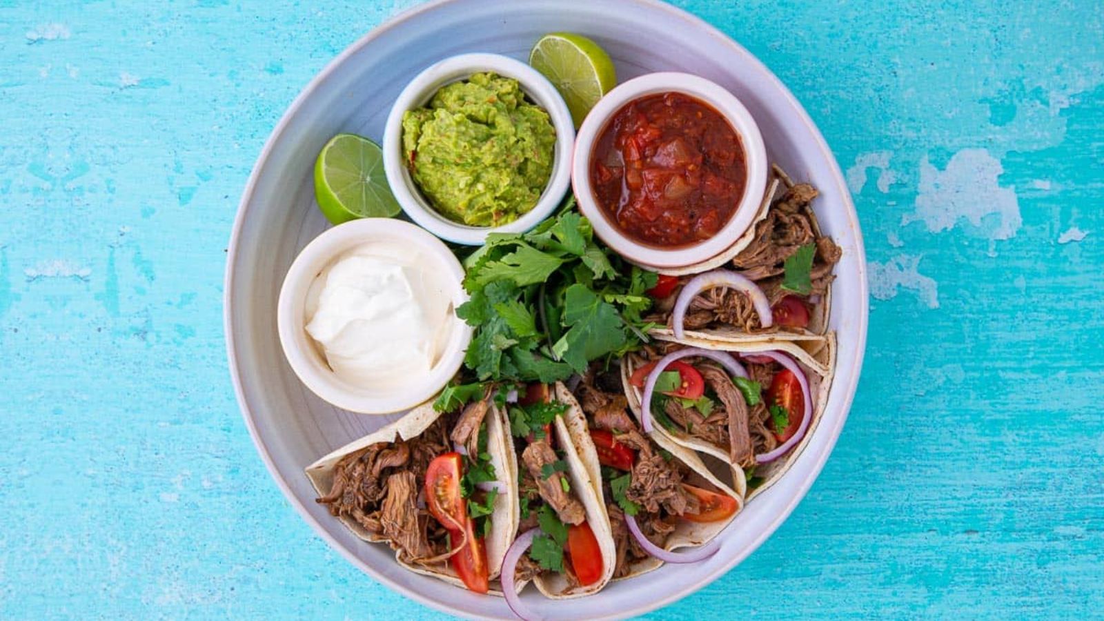 Lamb tacos with dips on the side.