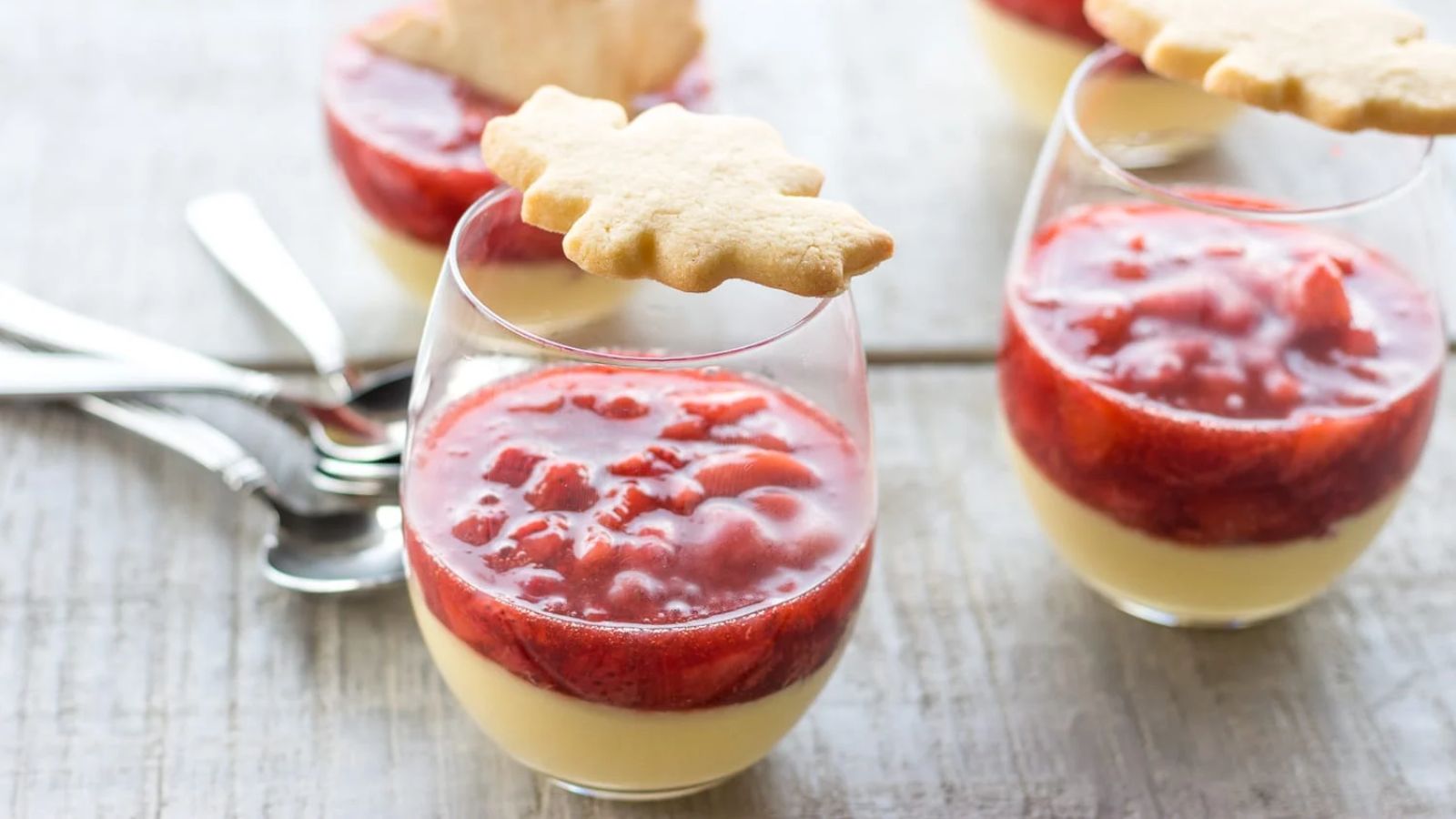 Maple custard with strawberry in two glasses.