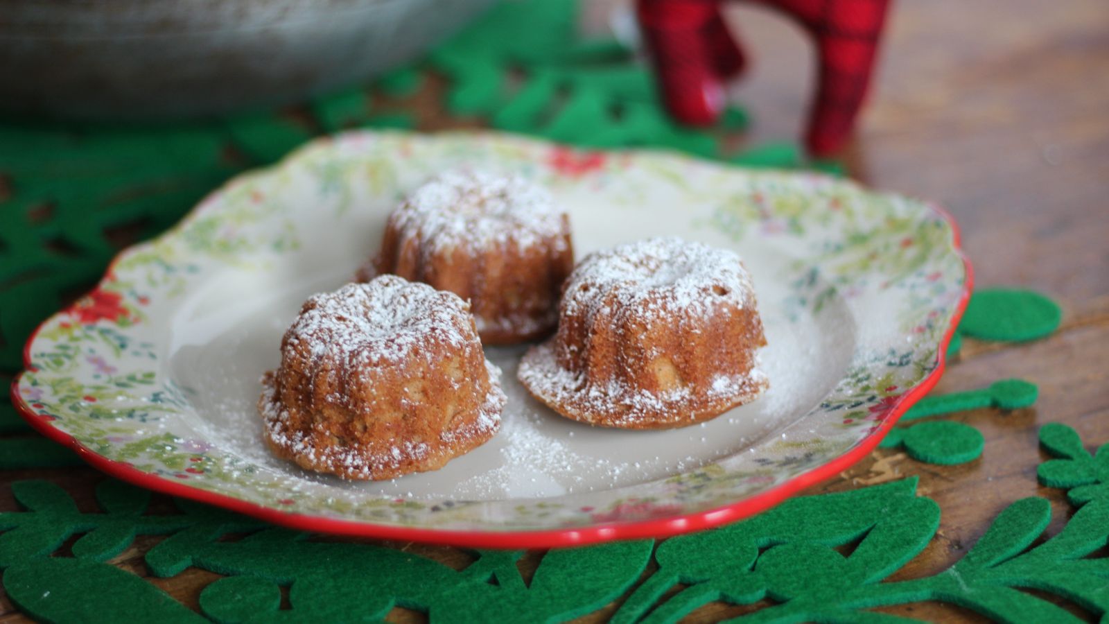 Mini gingerbread bundt cakes on a plate.