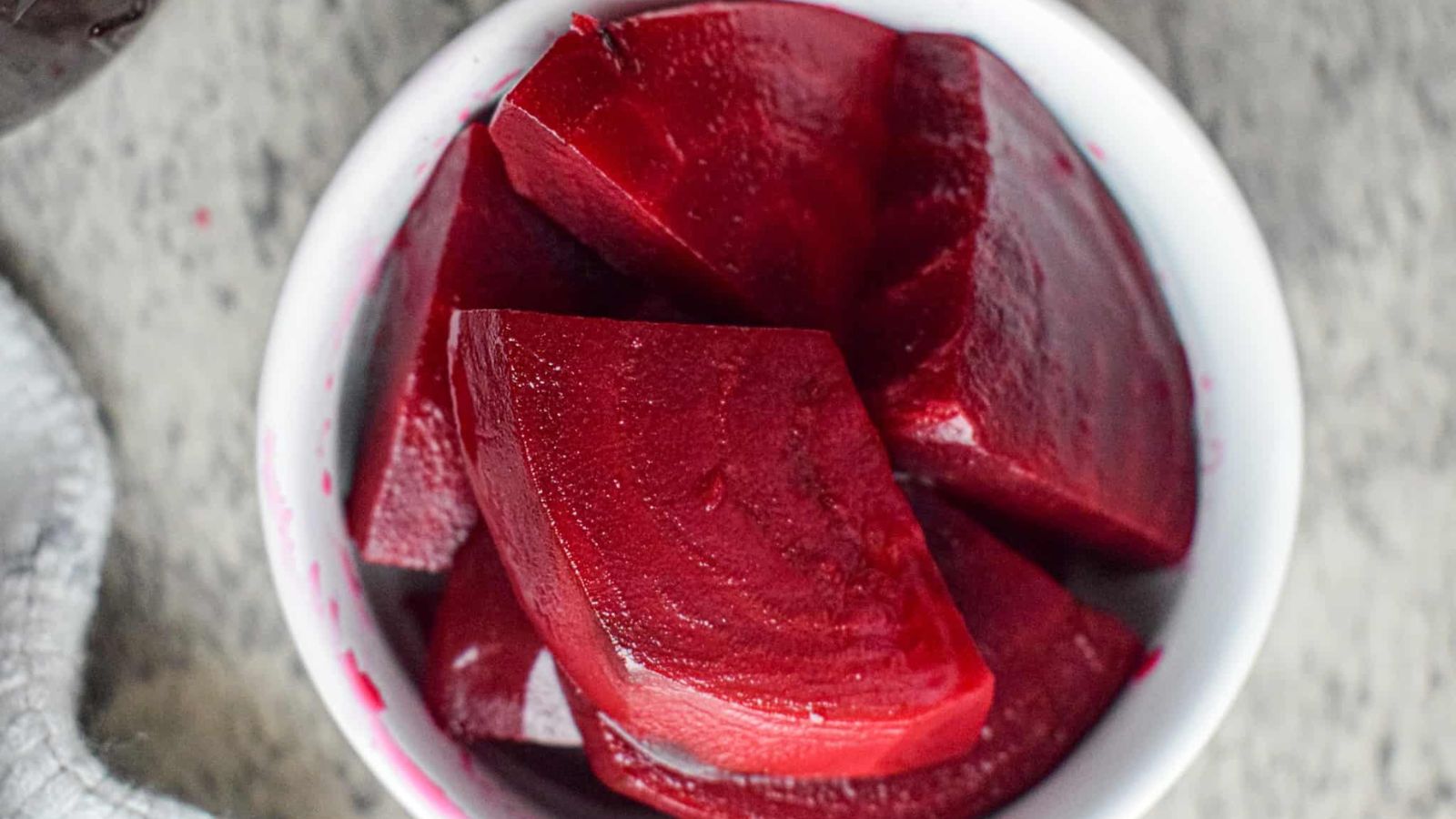 Pickled beets in a white bowl.