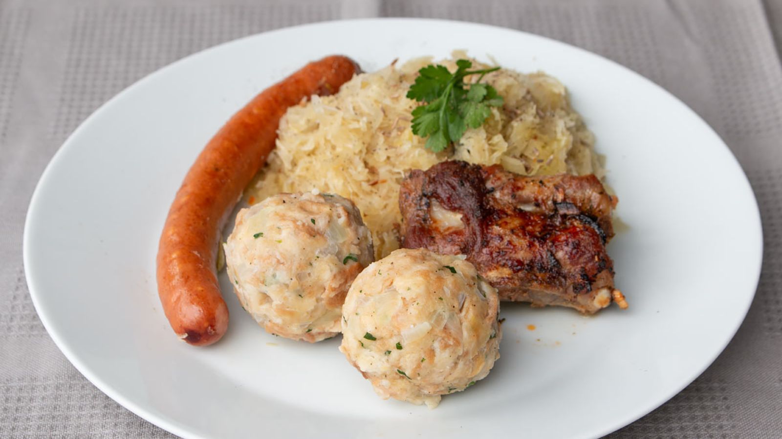 Meatballs and sausage on a plate.