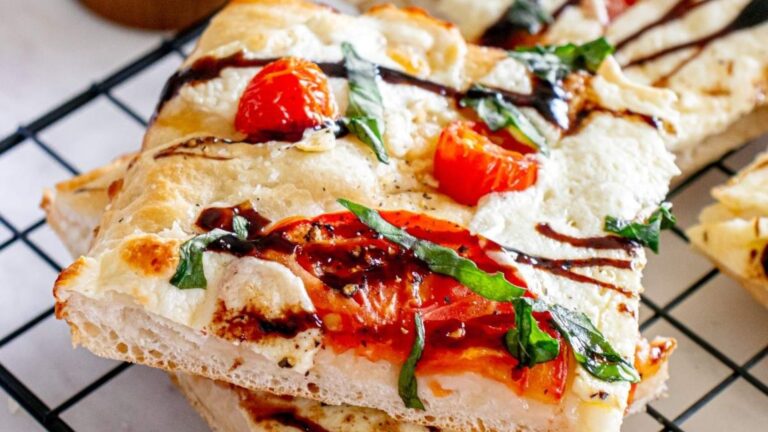 Slices of sheet pan caprese pizza.