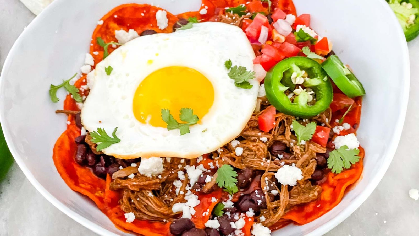 Beef red chilaquiles with sunny side up egg.