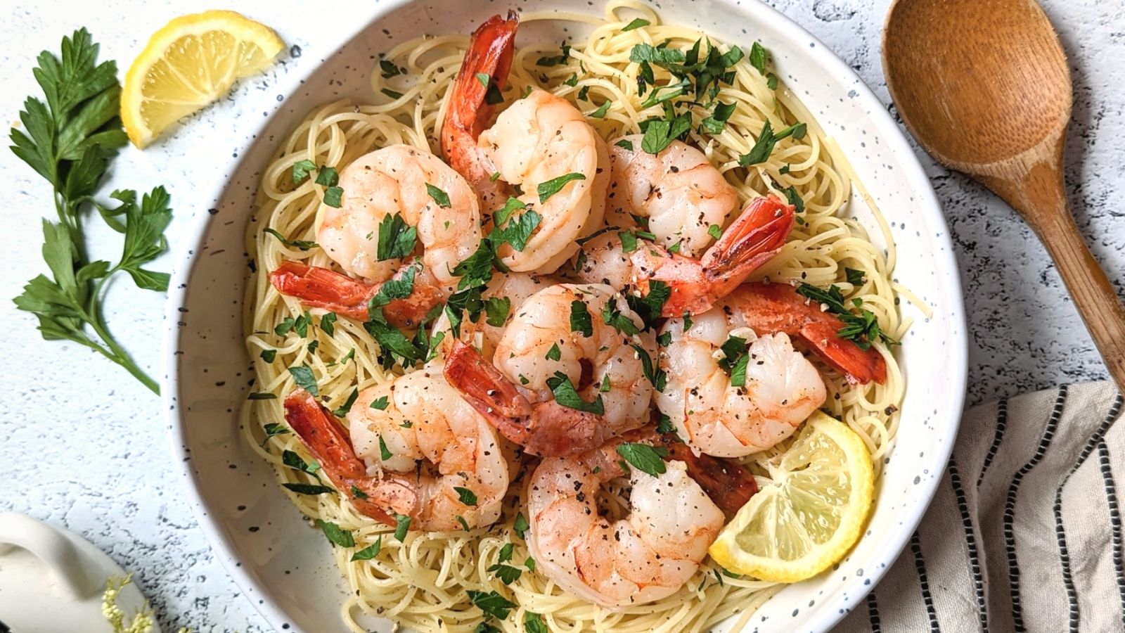 Pasta with shrimp and sliced lemon on top.