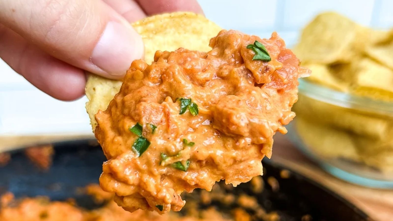 Chip dipped in a queso chorizo dip.