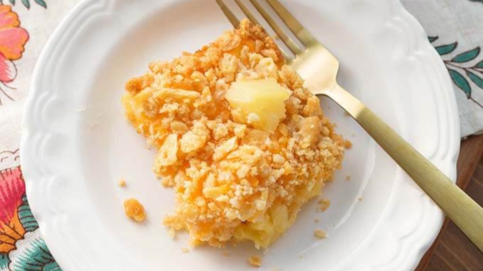 A portion of pineapple casserole on a plate.