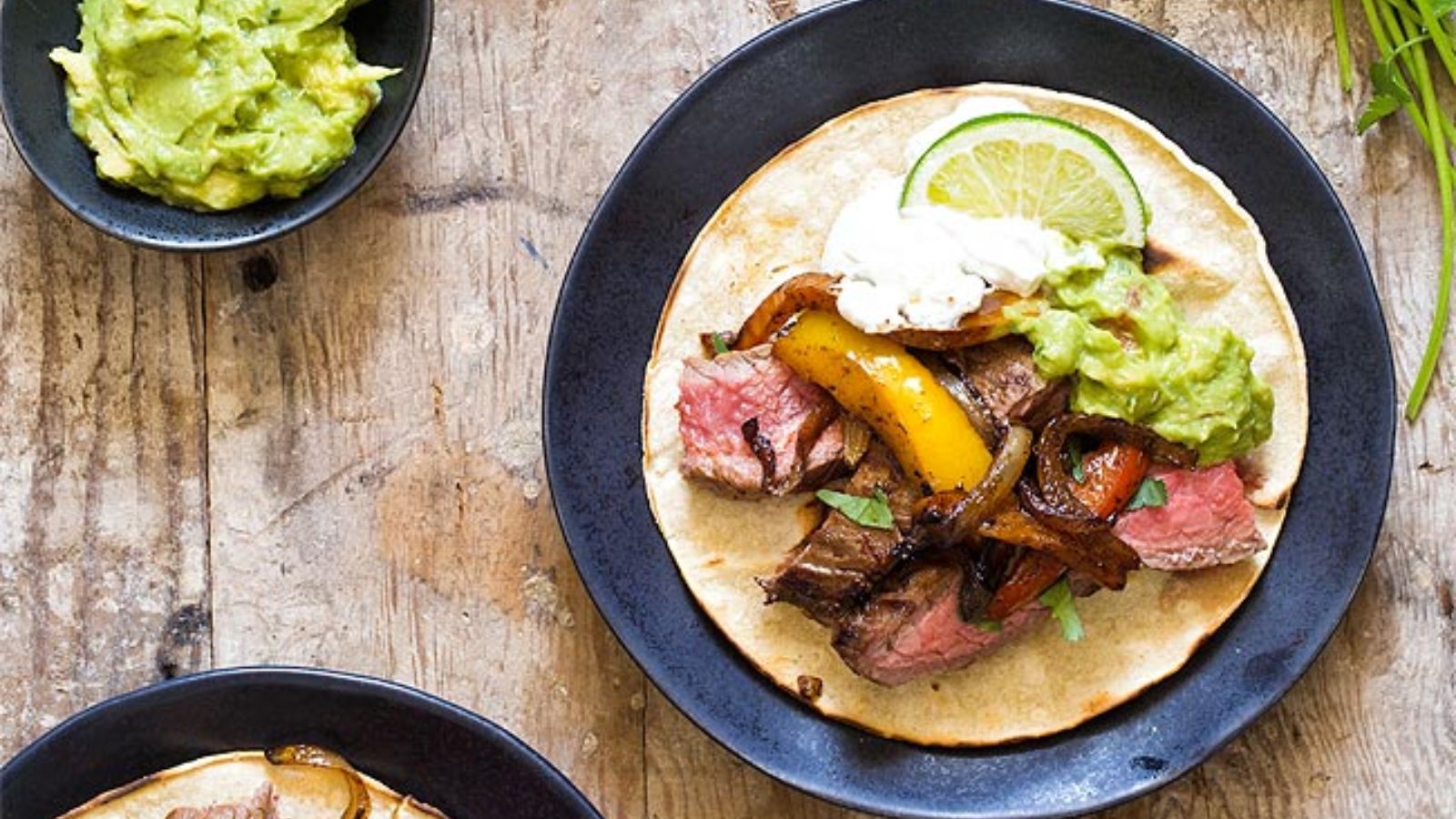 Steak fajitas with sliced lime.