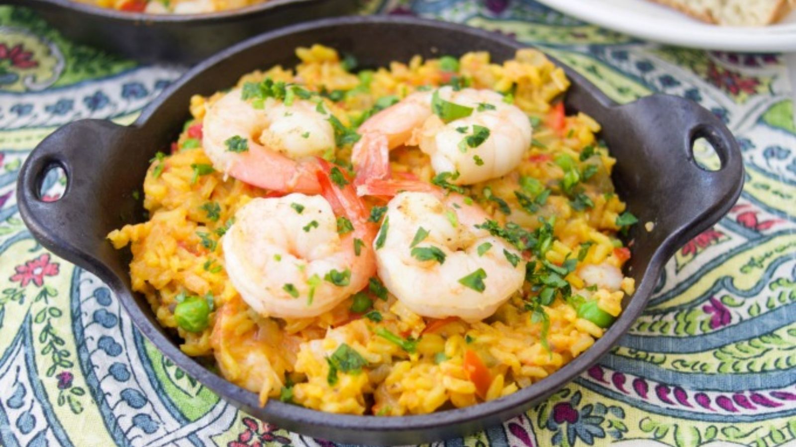 Yellow rice with shrimp on top.