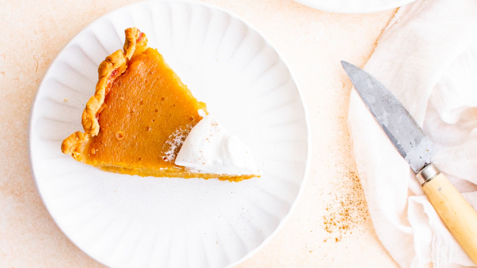 A slice of butternut squash pie on a plate.