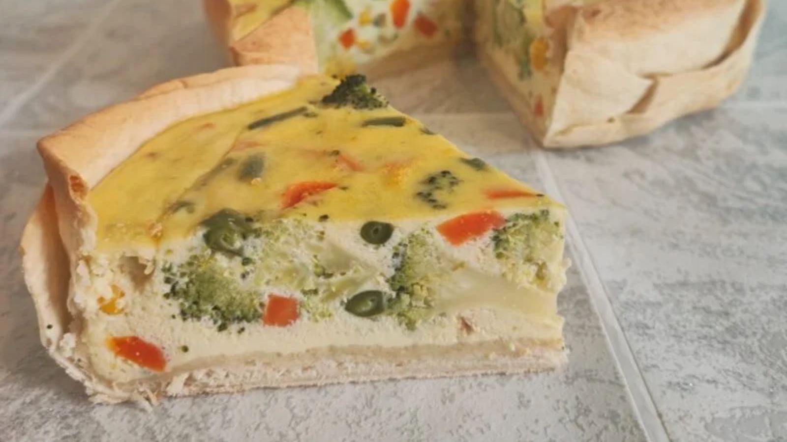 A slice of vegetable quiche.