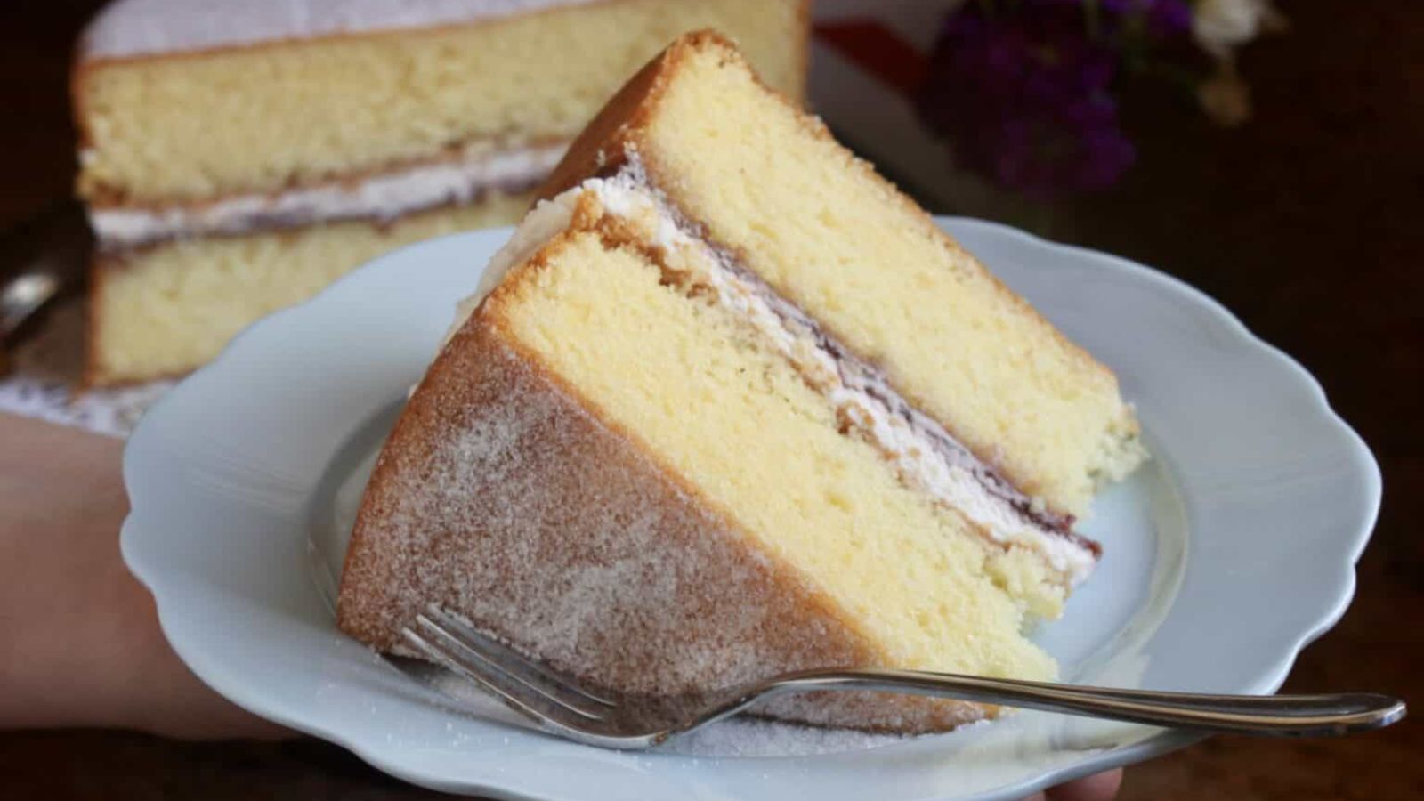 A slice of sponge cake on a plate.