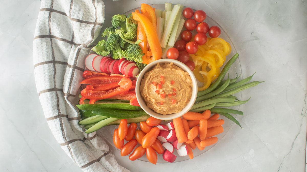 More vegetables assembled on the board.