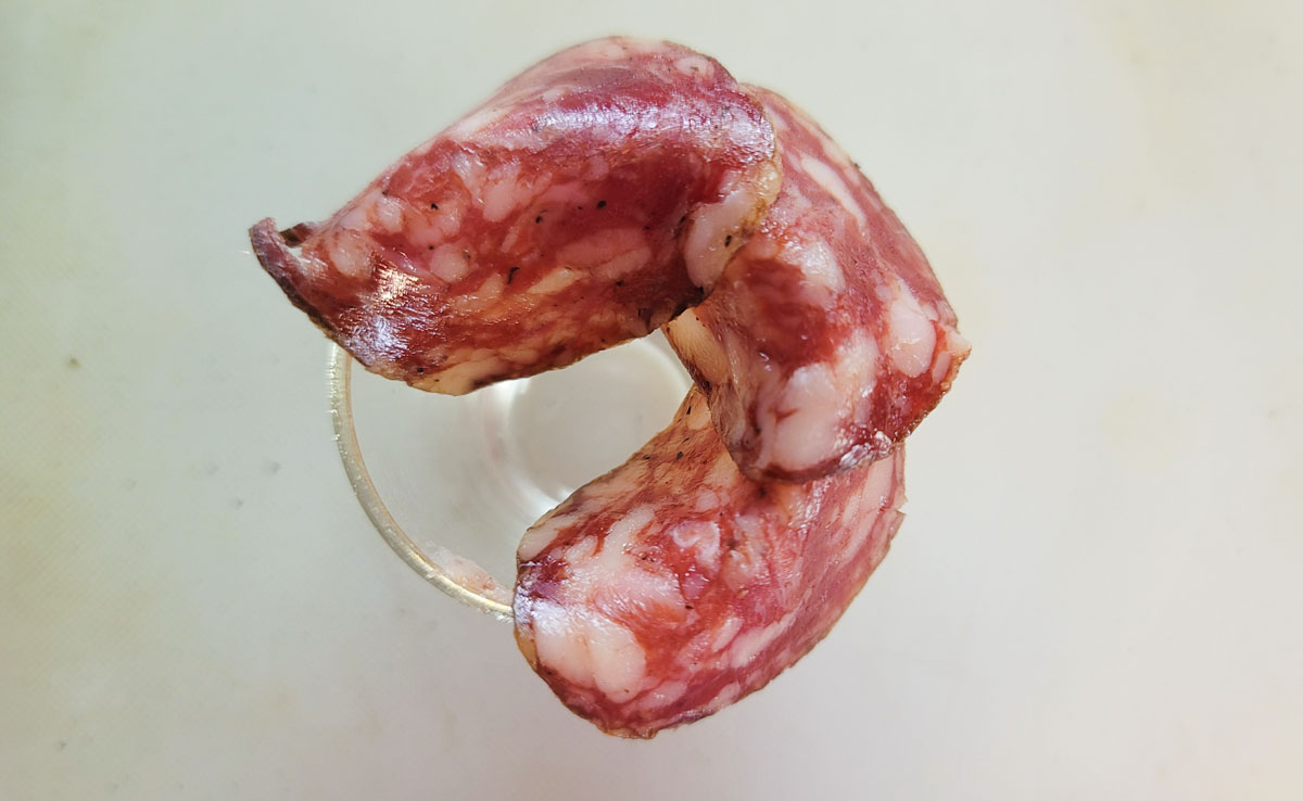 Shot glass with another piece of salami added.