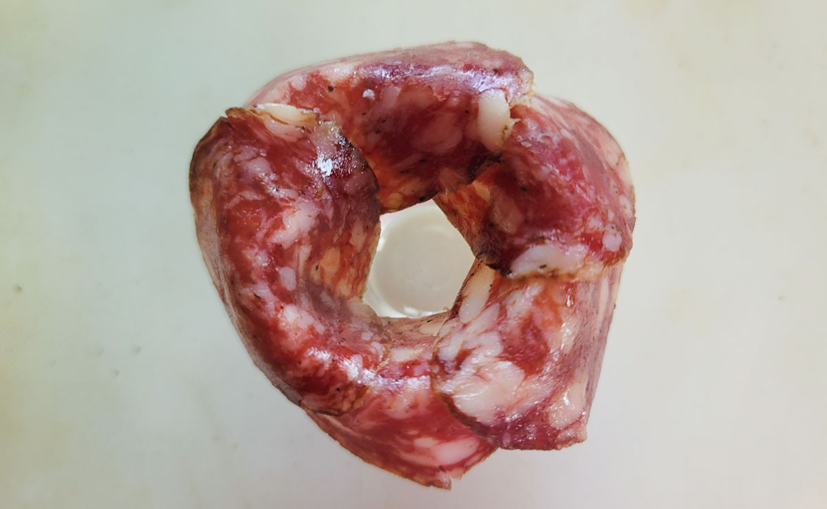 More salami added to the rim of the shot glass.