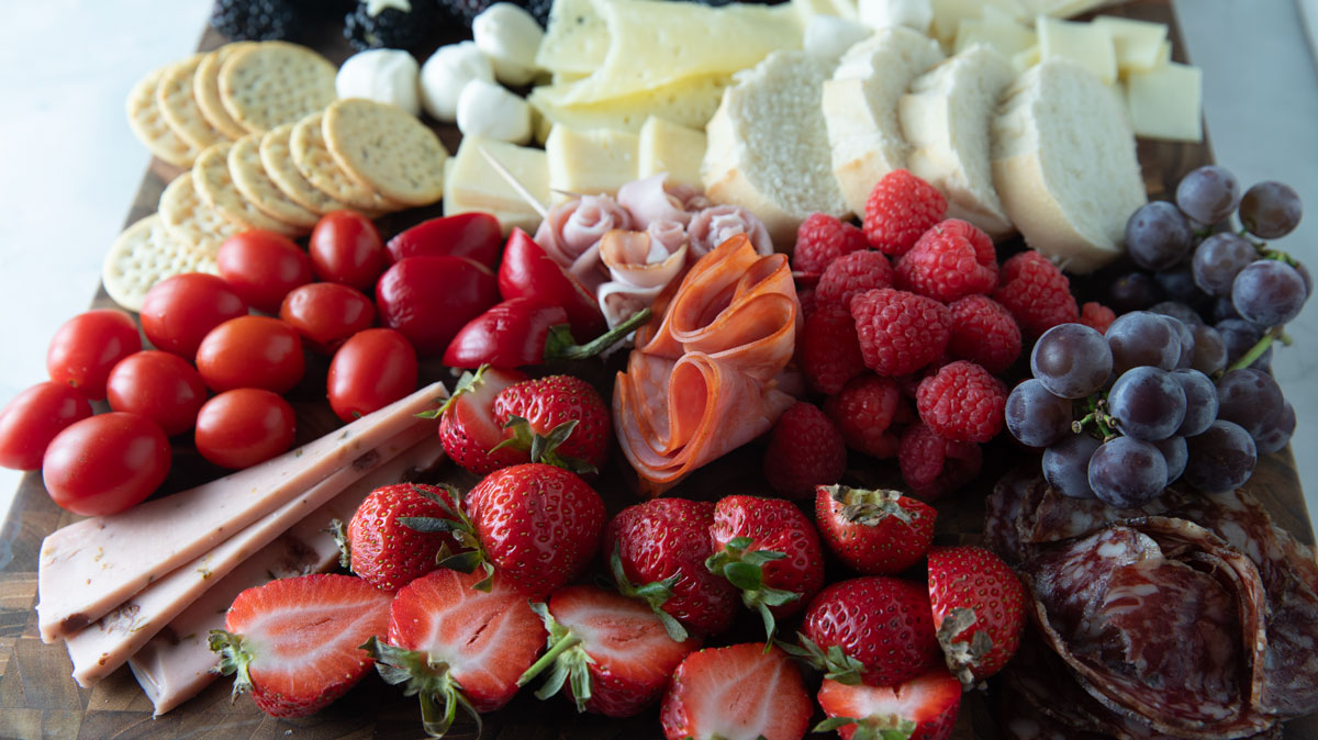 Red fruits with white cheeses and breads.