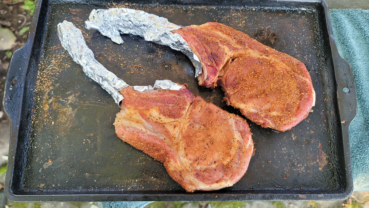 Pork chops after smoking on a metal tray.