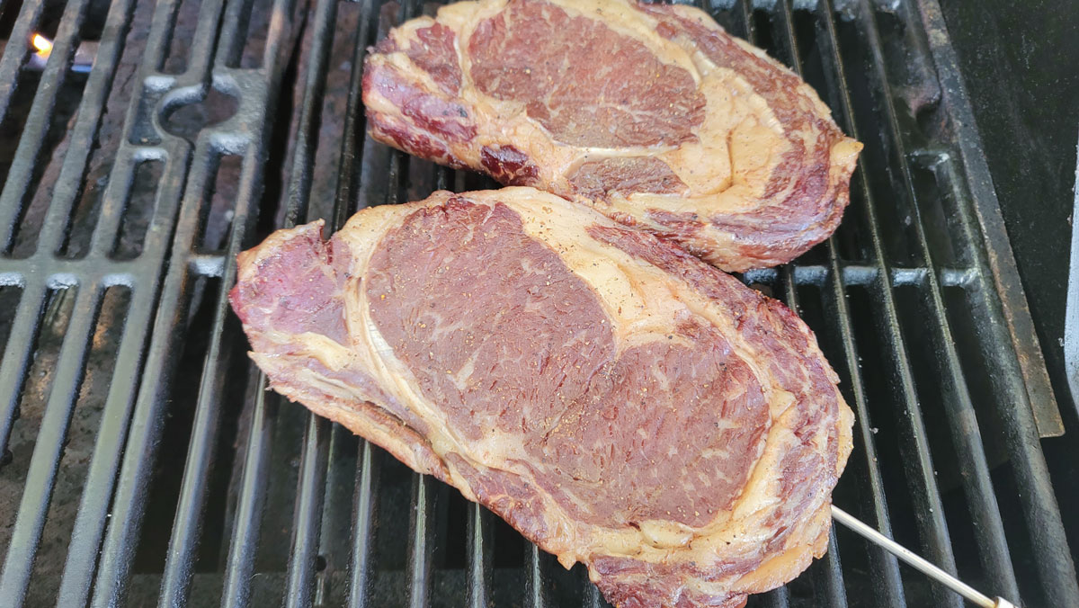 Chops on grill grates with an internal probe.