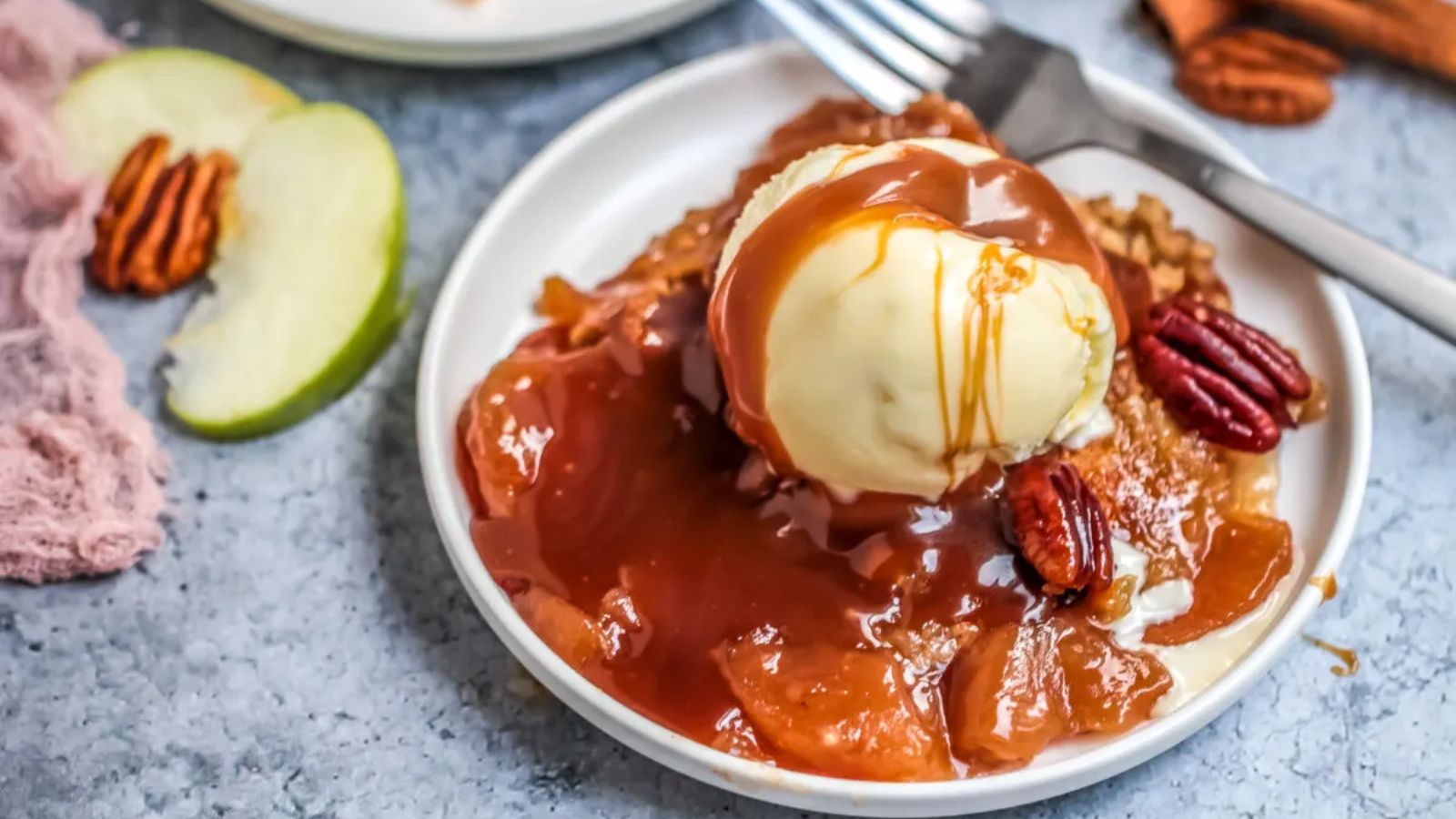 Apple dump cake with a scoop of ice cream on top.