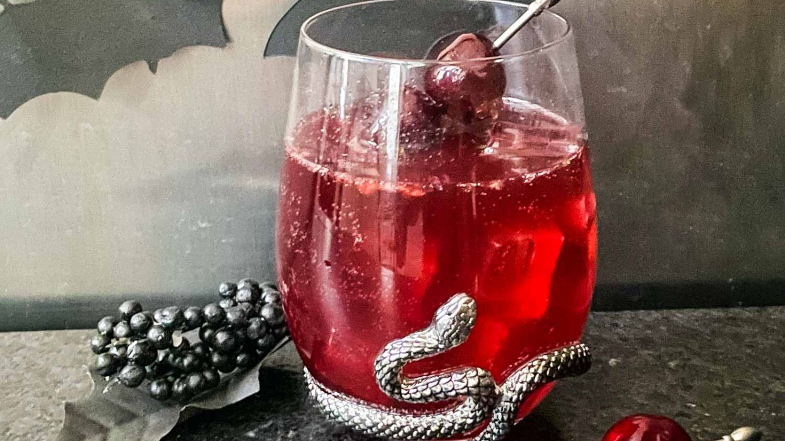 Cocktail in a glass with snake design.
