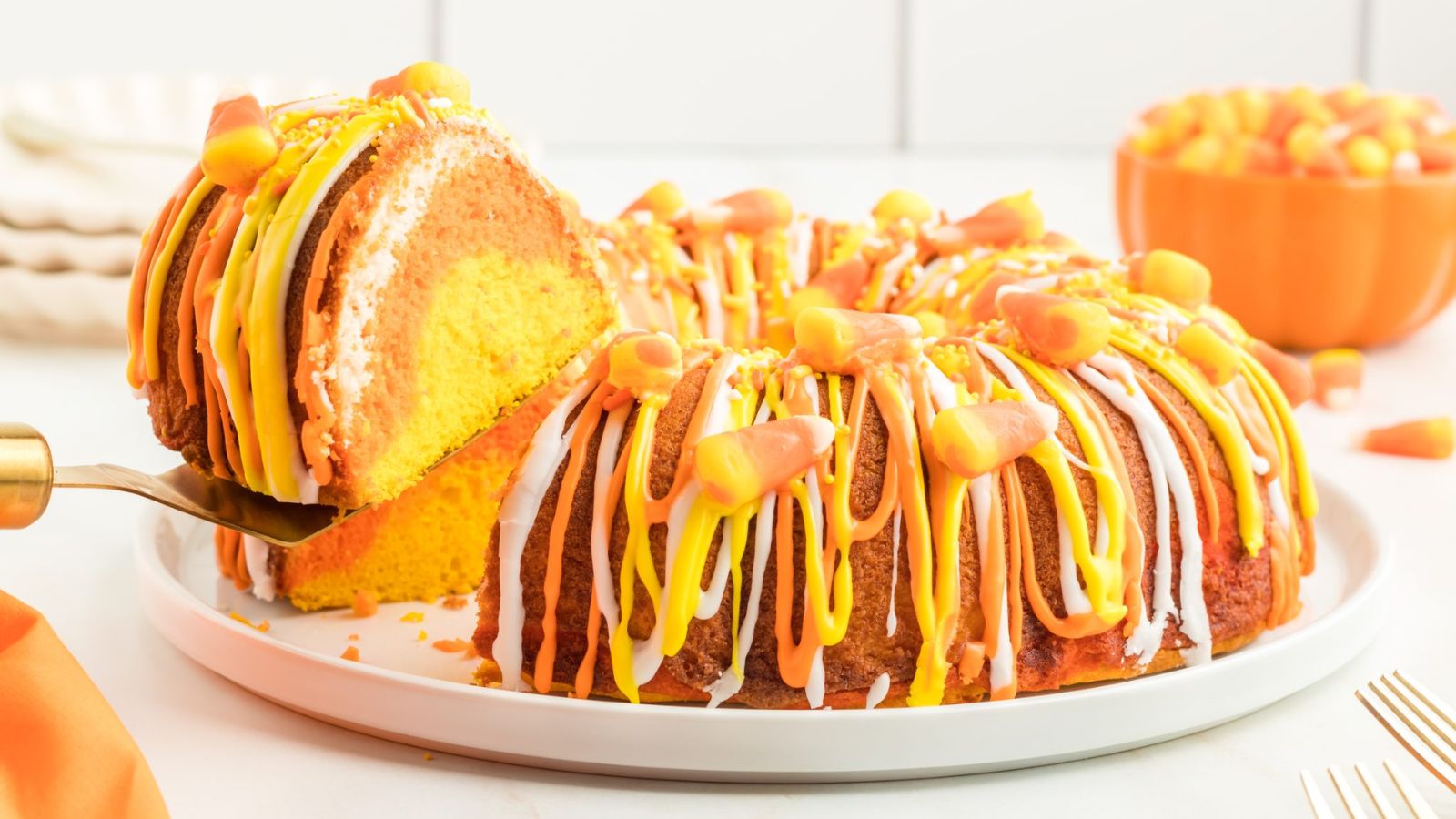 Candy corn bundt cake with slice.